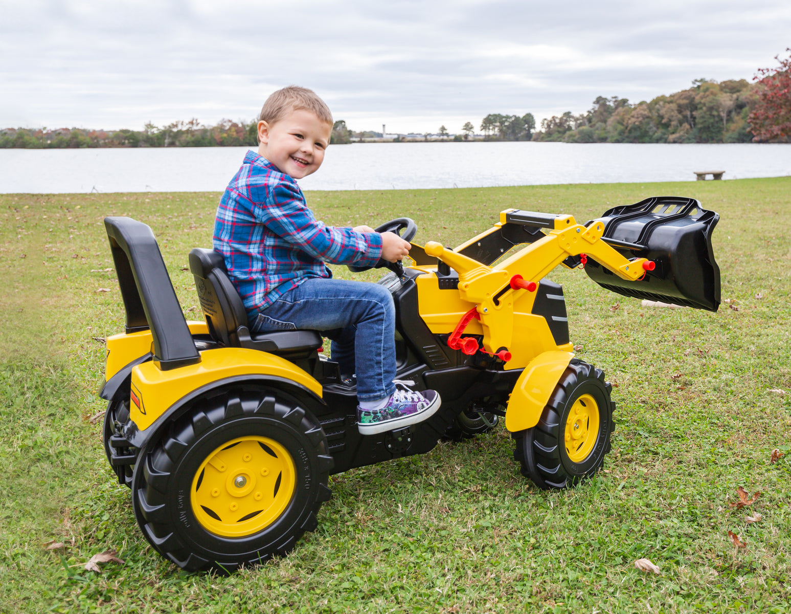 Child on CAT brand childrens pedal tractor