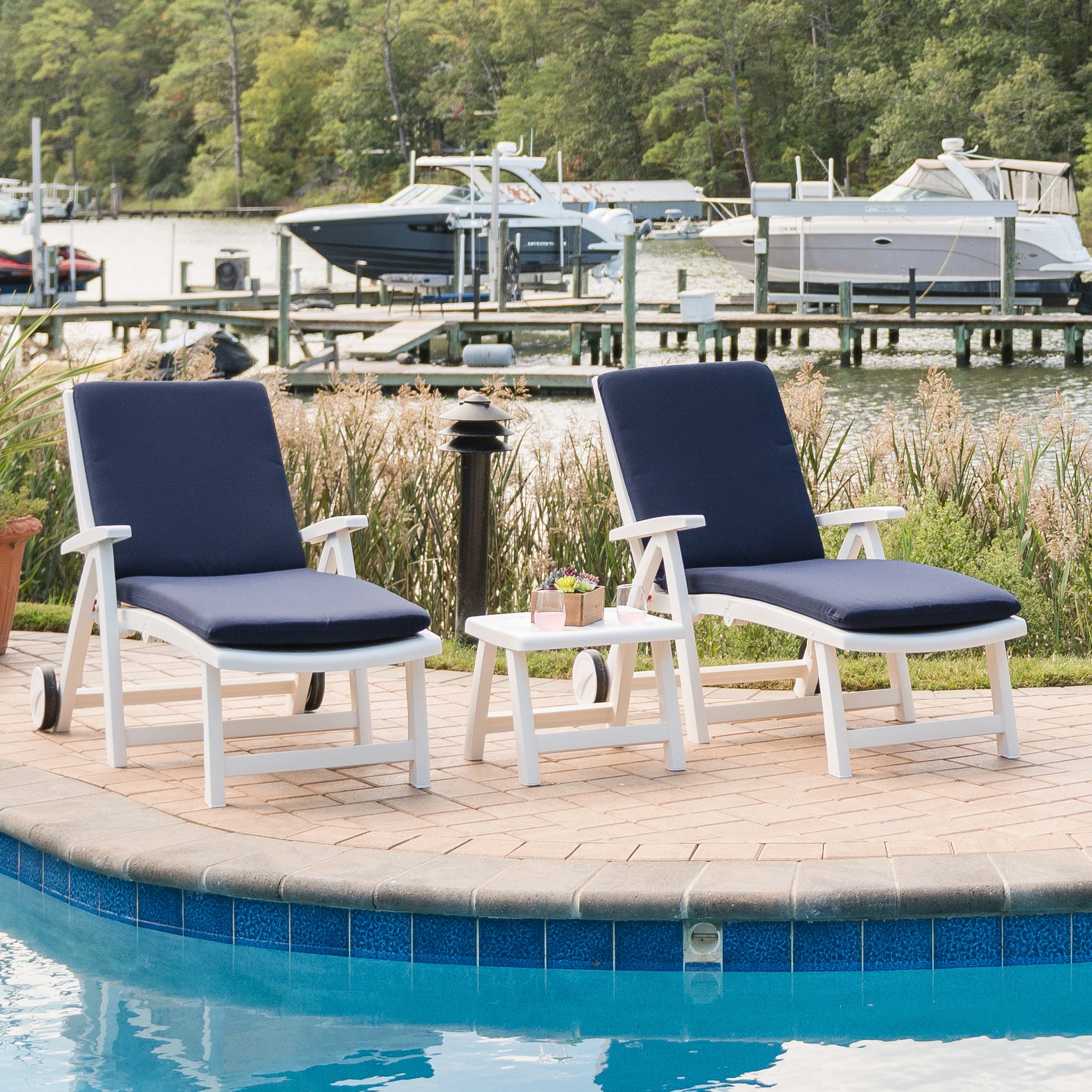 Roma lounger chairs and ottoman with navy cushions lifestyle